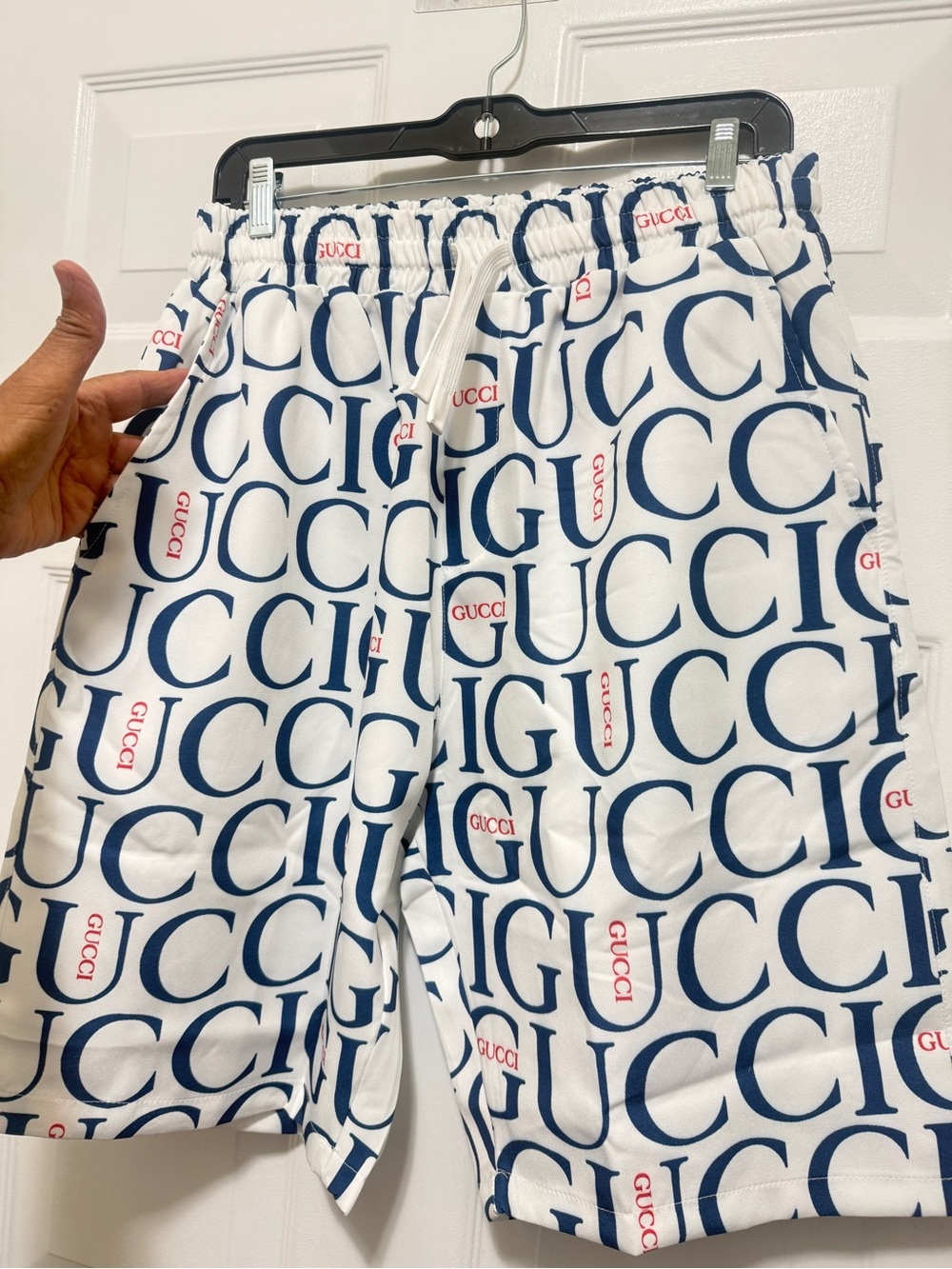 Beautiful shorts featuring a navy-and-red logo print with red accents. new - Picture 4 of 11